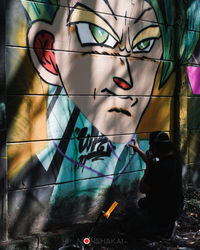 Portrait of man with graffiti on wall