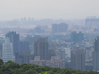 Modern buildings in city against sky