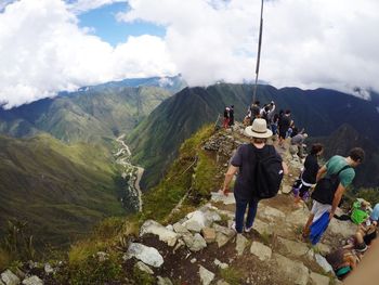 People in mountains against sky