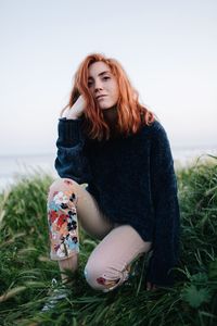 Beautiful woman sitting on a land