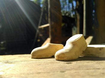 Close-up of shoes on wooden table