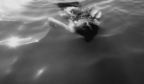 High angle view of girl swimming in lake