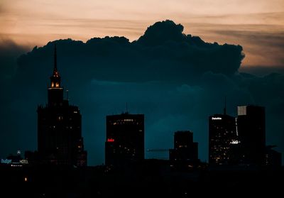 View of city lit up at sunset