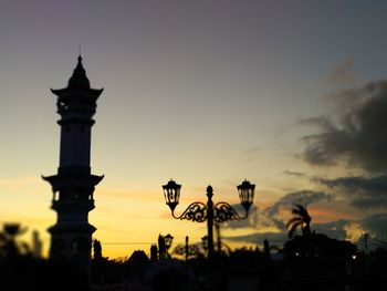 Silhouette building against sky during sunset