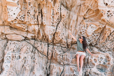 Midsection of woman standing on rock