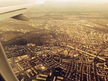 Aerial view of cityscape seen through airplane window