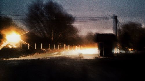 Silhouette trees against sky at night
