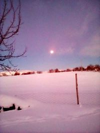 Snow covered landscape against sky