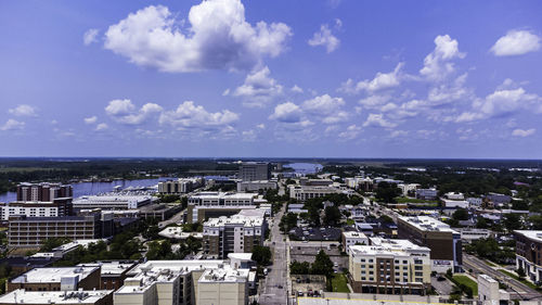 High angle view of buildings and sea against sky