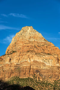 Low angle view of rocky mountain against sky