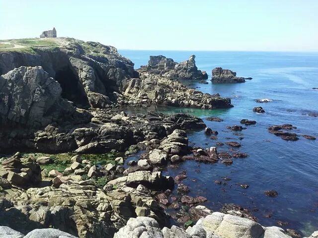 sea, water, horizon over water, rock - object, rock formation, tranquility, tranquil scene, scenics, clear sky, rock, beach, beauty in nature, cliff, nature, shore, sky, stone - object, idyllic, high angle view, travel destinations