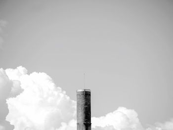 Low angle view of smoke emitting from chimney against sky