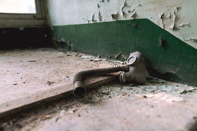 Close-up of old gas mask on floor