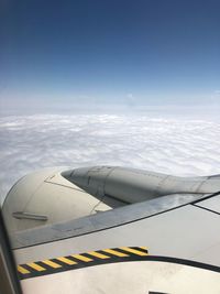 Airplane flying over cloudy sky