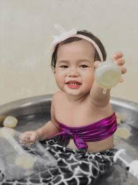 Portrait of cute girl holding water