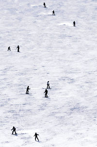 High angle view of people on snow covered land