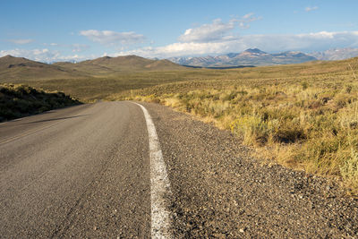 Scenic view of road by land against sky