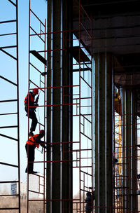 Man working on glass window of building
