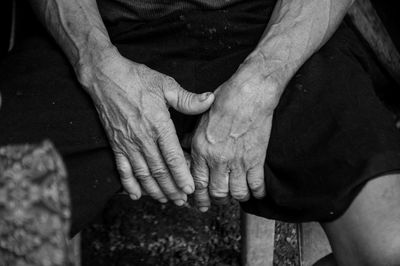 Close-up of man touching hands