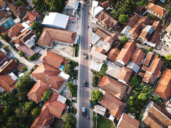 Aerial view of road amidst houses in city