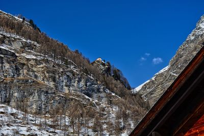 Zermatt low angle view of snowcapped mountains against blue sky