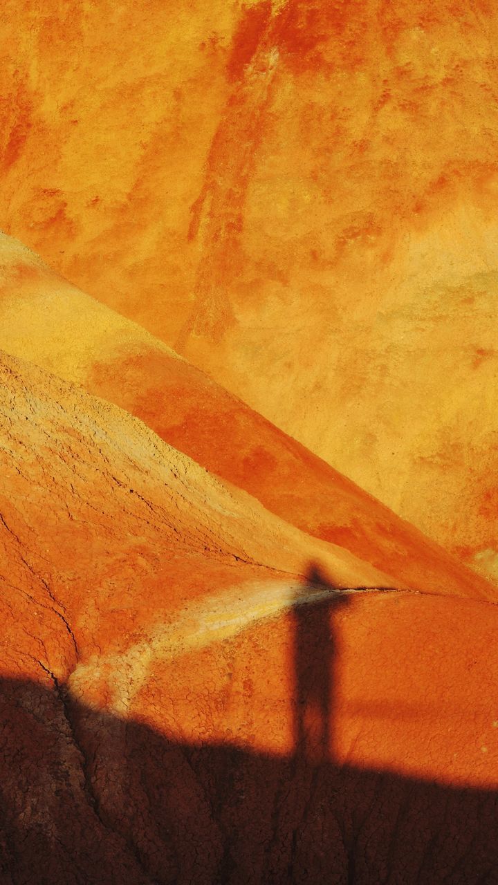 textured, shadow, full frame, orange color, backgrounds, sunlight, pattern, close-up, no people, brown, high angle view, outdoors, day, selective focus, wall - building feature, detail, nature, sand, rough