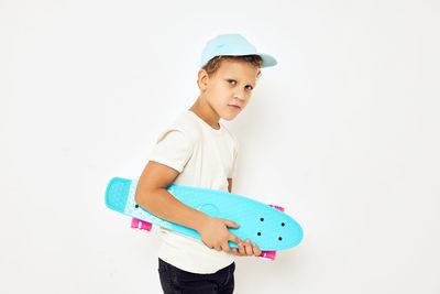 Portrait of boy standing against white background