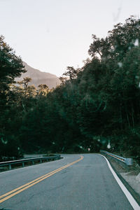 Road amidst trees against sky