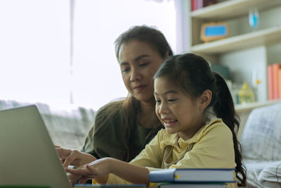 Young woman using laptop at home