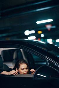 Thoughtful woman sitting in car