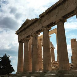 Low angle view of colonnade against sky