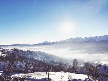 Scenic view of snow covered mountains against sky