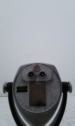 Close-up of coin-operated binoculars against clear sky