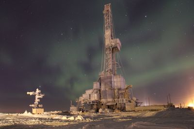 Communications tower against sky at night