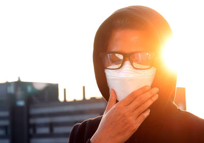 Close-up of man wearing flu mask standing outdoors