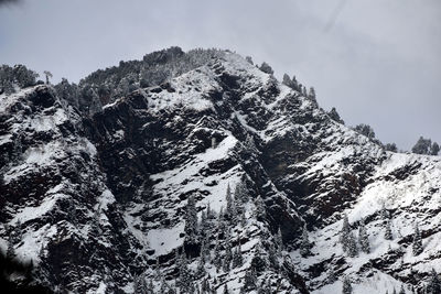 Low angle view of snowcapped mountain against sky