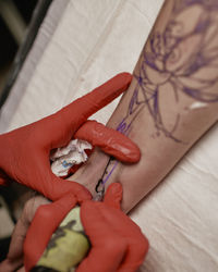 High angle view of woman hand on bed