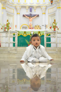 Portrait of baby sitting  in church