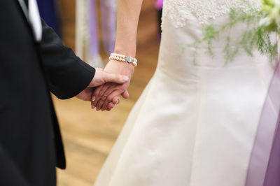 Close-up of couple holding hands