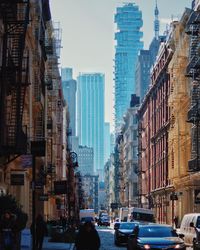 Cars on road amidst buildings