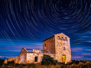 Low angle view of old building against sky at night