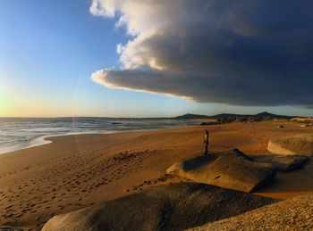 Scenic view of beach against sky during sunset