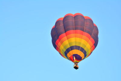 Low angle view of hot air balloon against blue sky