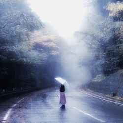 Woman walking on road