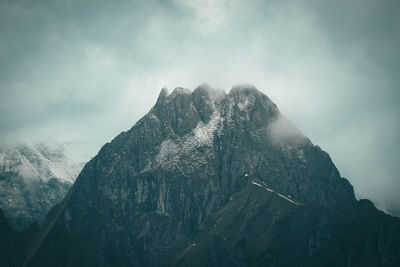 Scenic view of a mountain surrounded by clouds