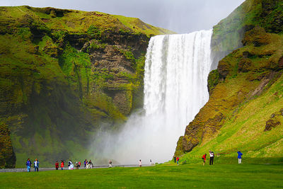 People against waterfall