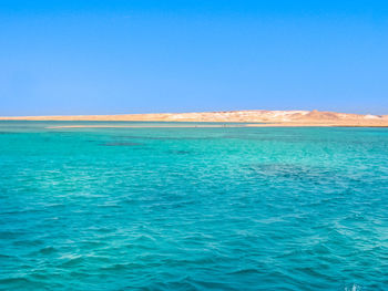 Scenic view of sea against clear blue sky