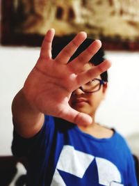 Close-up portrait of boy with hand