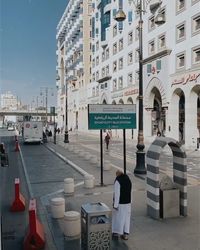 Text on street against buildings in city