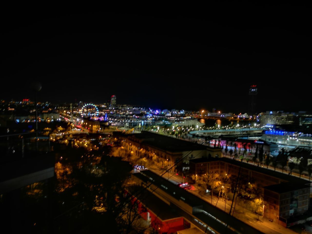 HIGH ANGLE VIEW OF ILLUMINATED CITY AT NIGHT